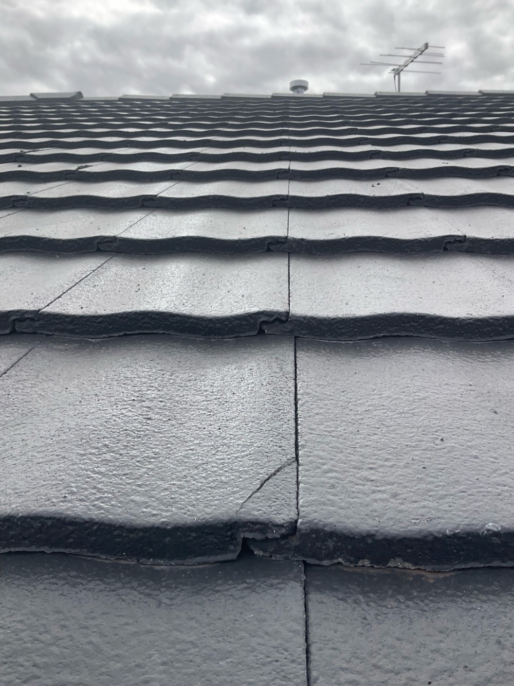 Broken and cracked roof tiles needing replacement, recorded during a pre-handover inspection in Aintree, 3 km from Rockbank